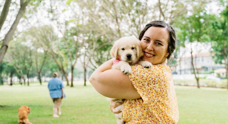 Woman holding Golden Retriever Puppy