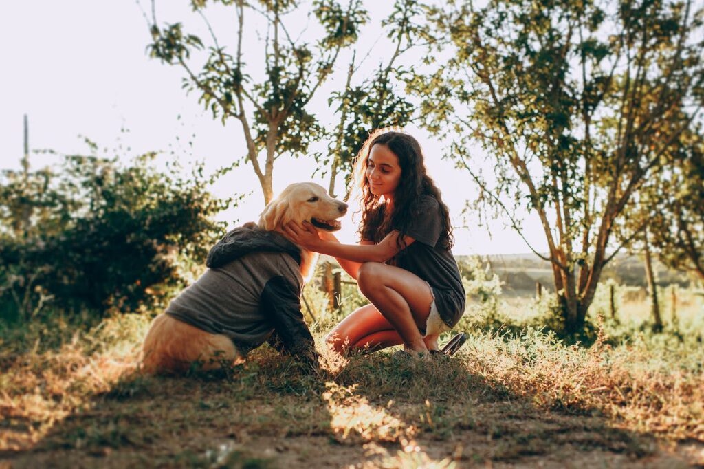 In the park with her Golden Retriever