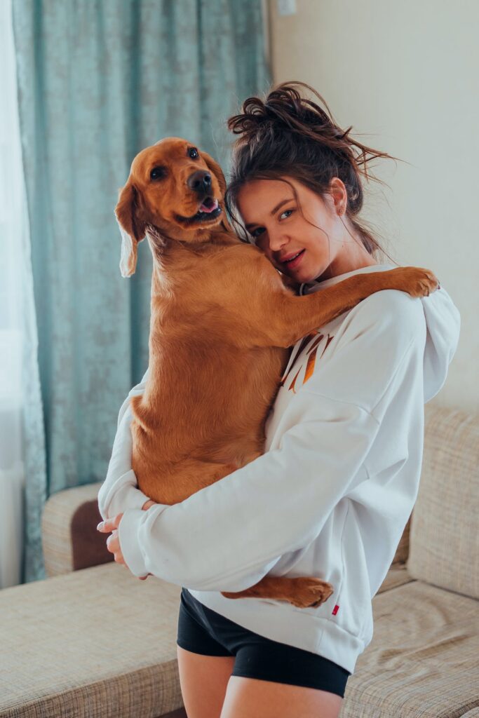 Cuddling her mixed breed dog